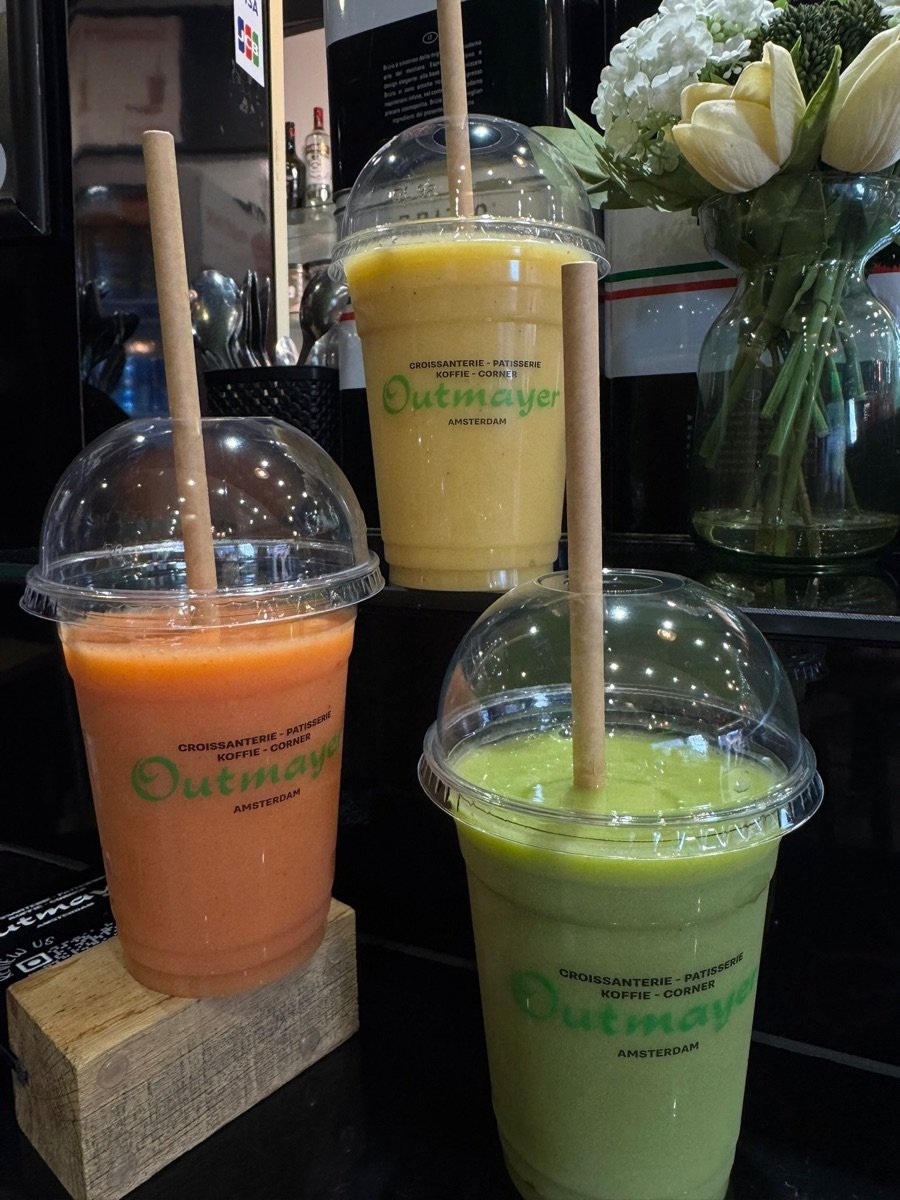 Three fresh fruit smoothies - red, mango and green - in Outmayer cups