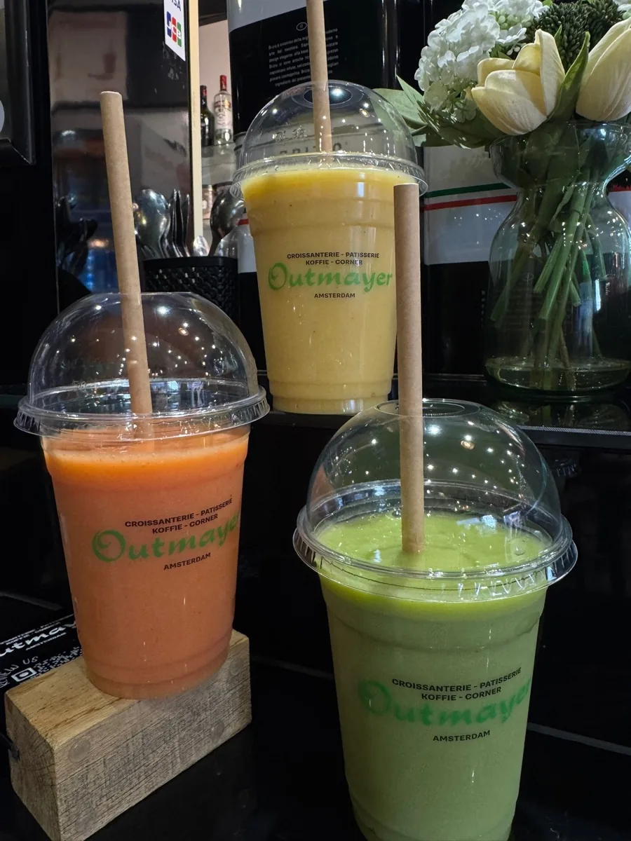 Three fresh fruit smoothies - red, mango and green - in Outmayer cups